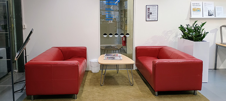 A pair of red ibrary couches